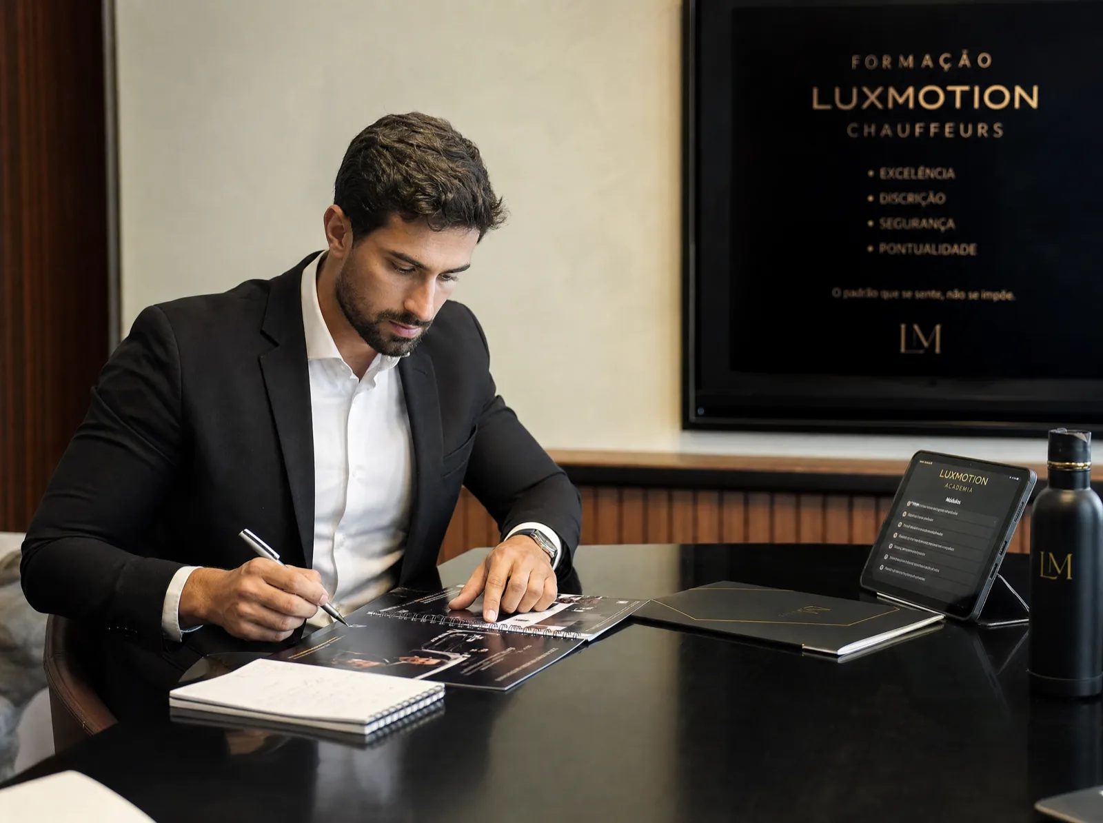 Chauffeur in training, with the LuxMotion service standards on screen