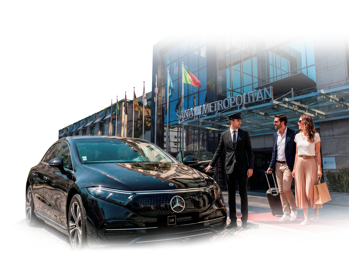 LuxMotion chauffeur welcoming guests beside a Mercedes outside a Lisbon hotel